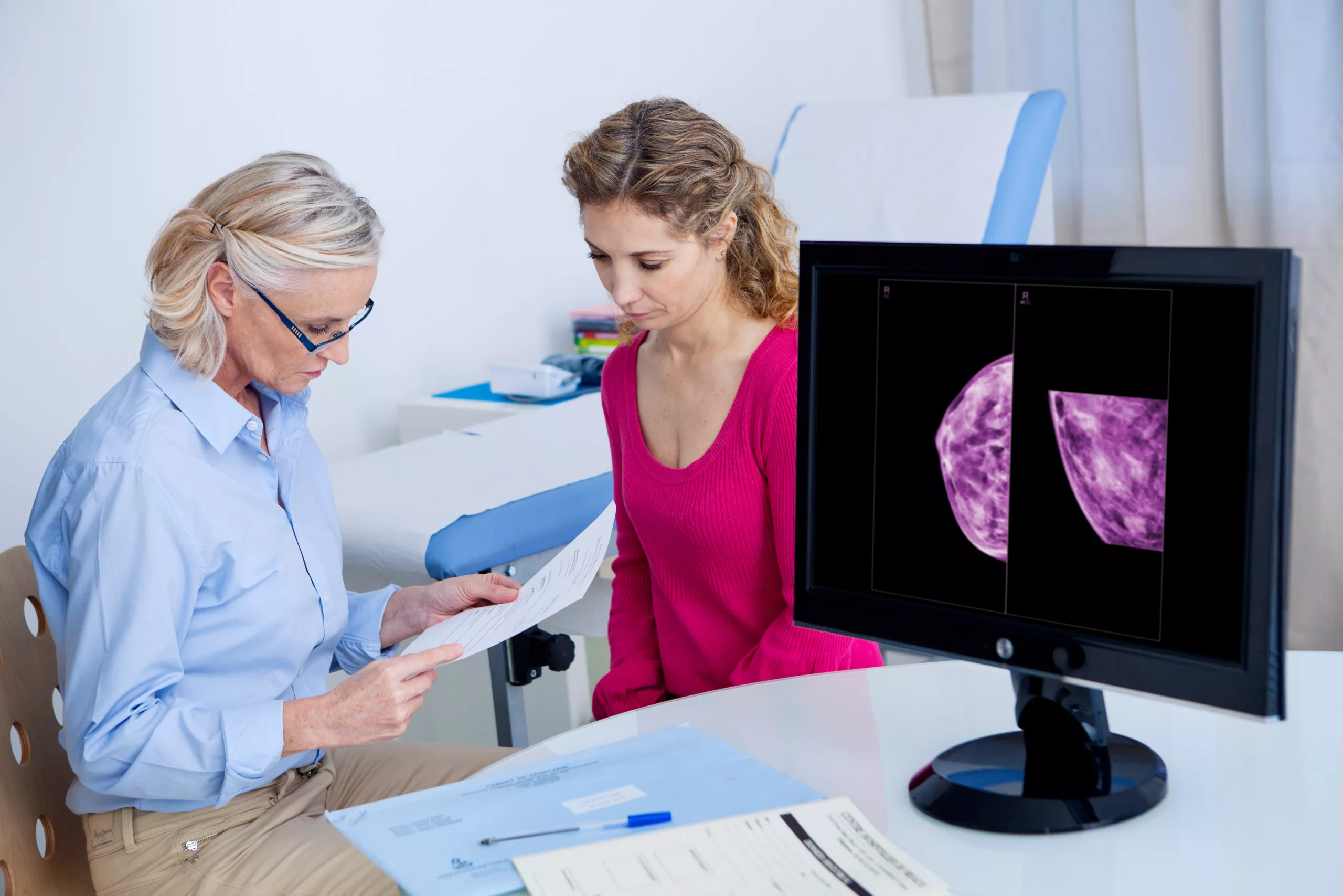 Reviewing mammogram results and treatment options A provider reviews mammogram results with a patient, discussing findings and next steps for breast cancer diagnosis and treatment planning.